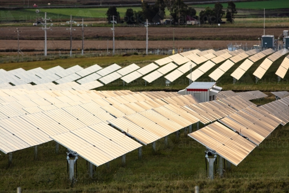 Tilting solar farm panels outside of Warwick at sunset - Australian Stock Image