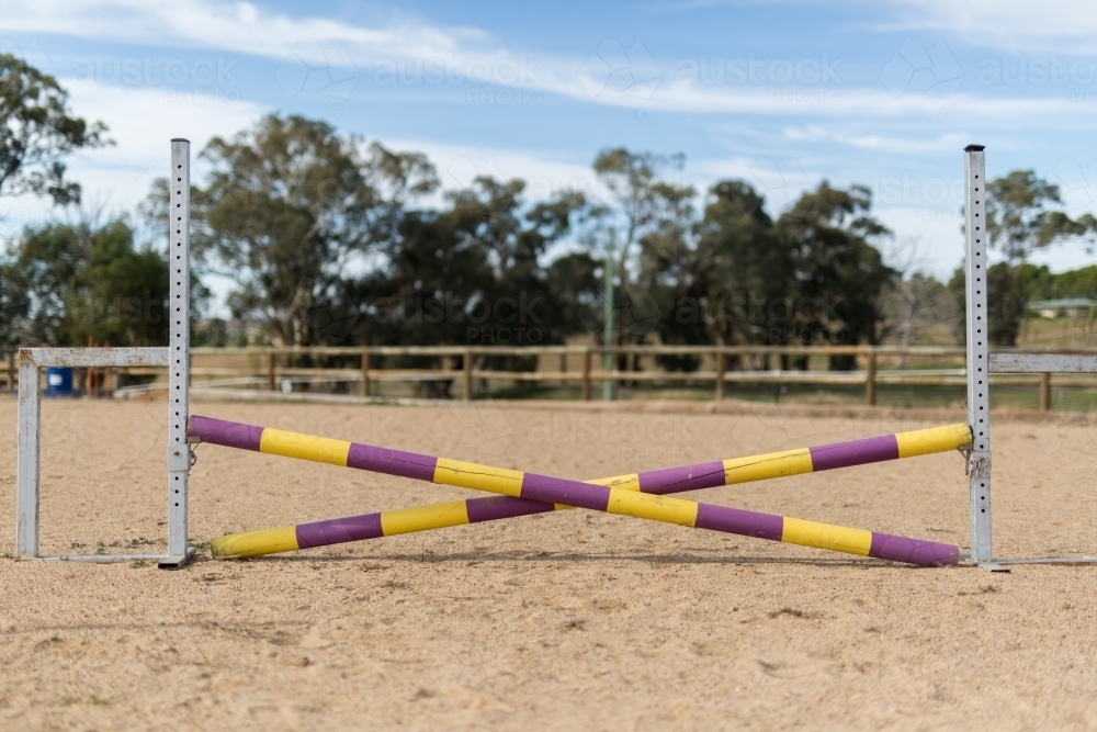 Timber jump set up for show jumping in a sand arena - Australian Stock Image