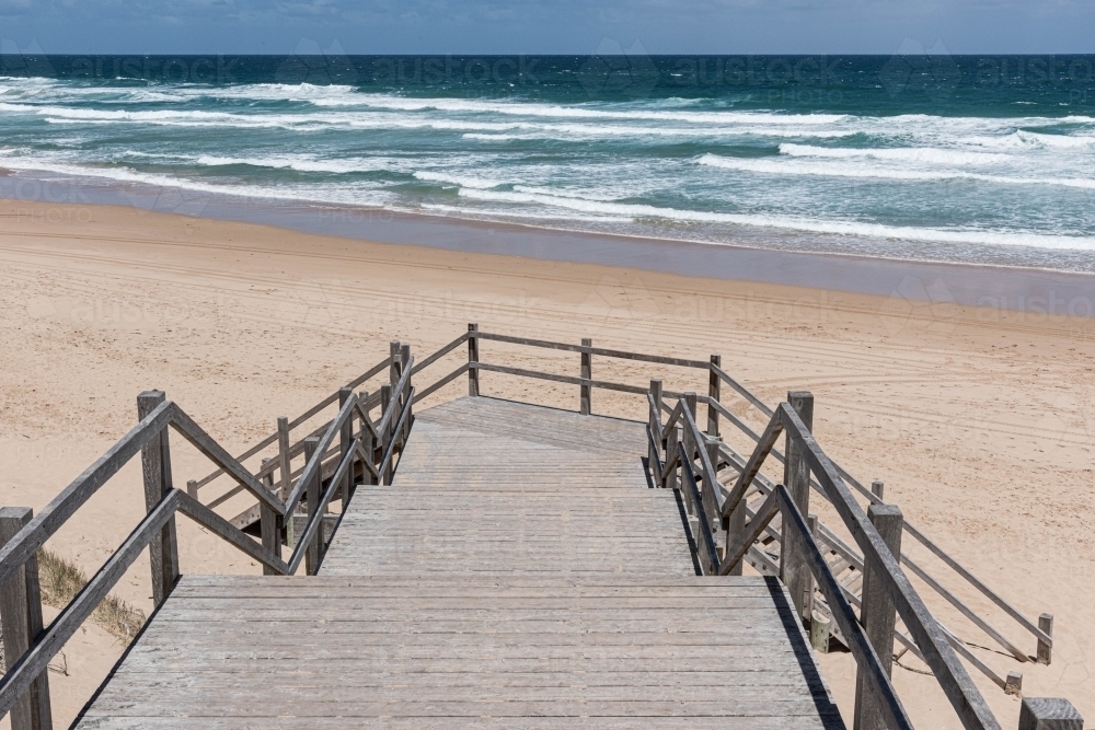 timber stairs leading onto the sand back beach - Australian Stock Image