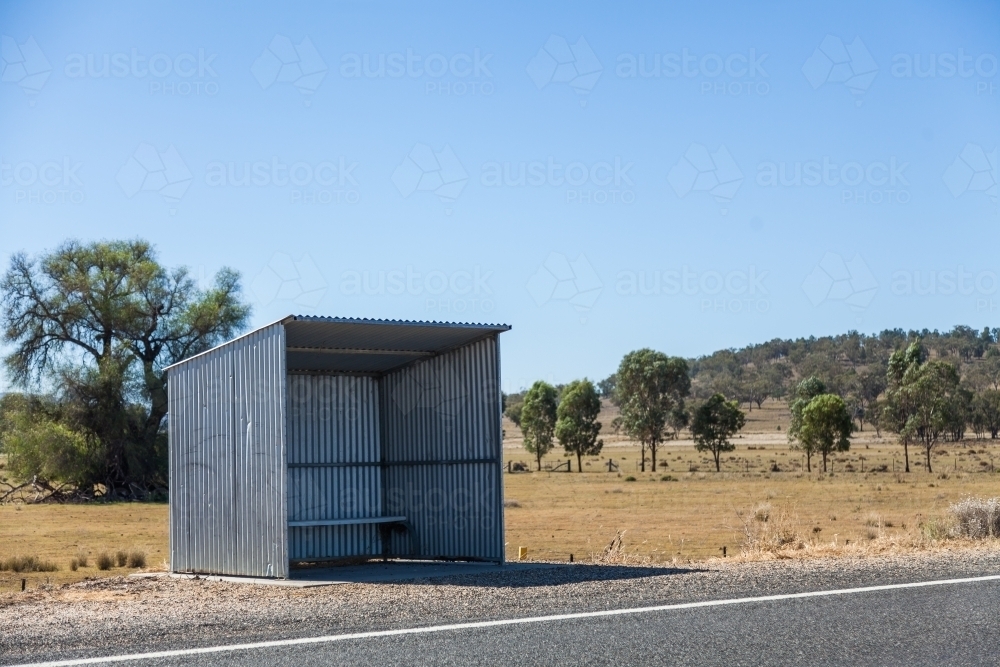 Tin school bus shelter on rural roadside - Australian Stock Image