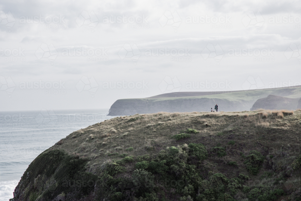 Tiny figure on high cliffs on the mornington peninsula - Australian Stock Image