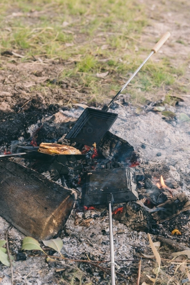 Toasted sandwiches, or jaffles, made on the campfire - Australian Stock Image