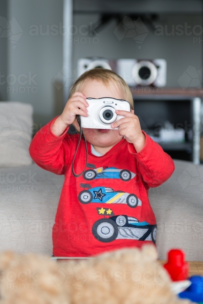 toddler boy with compact digital camera - Australian Stock Image