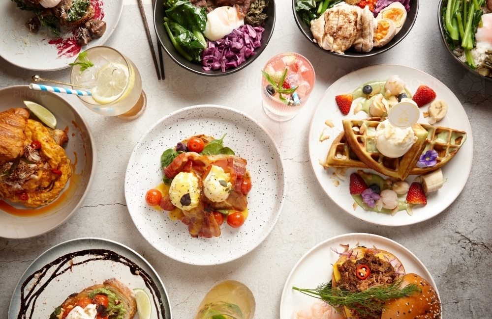 Top down of various appetising dishes on table - Australian Stock Image