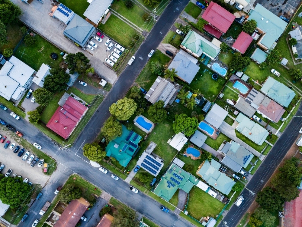 top down overhead view of houses with pools in backyard and streets - Australian Stock Image