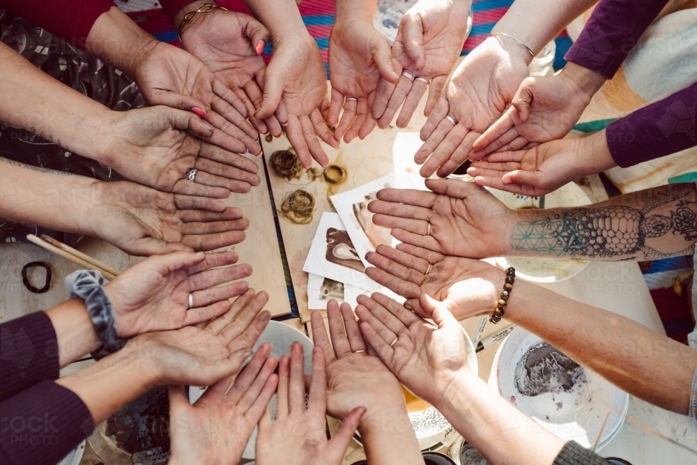 Top down view of hands in a circle - Australian Stock Image