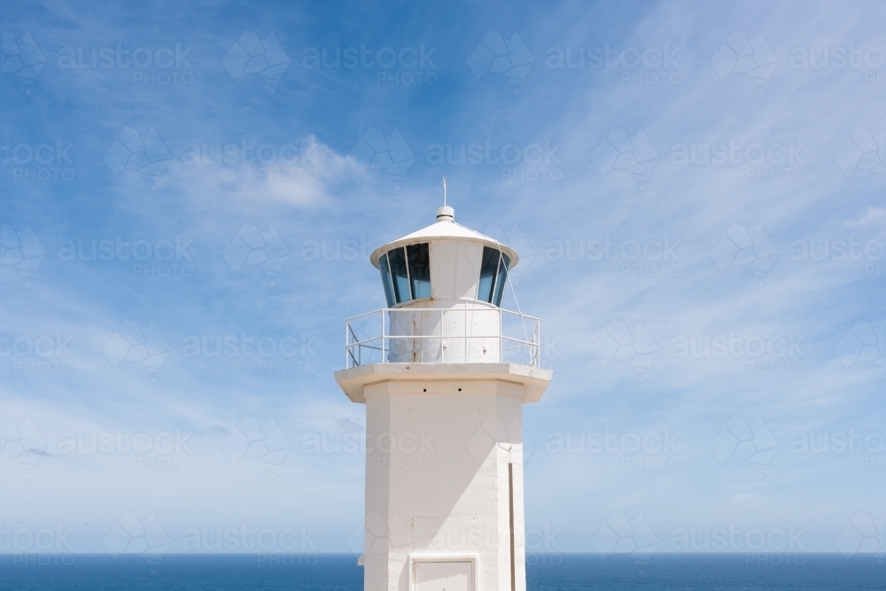 Top of lighthouse against a blue sky and ocean - Australian Stock Image