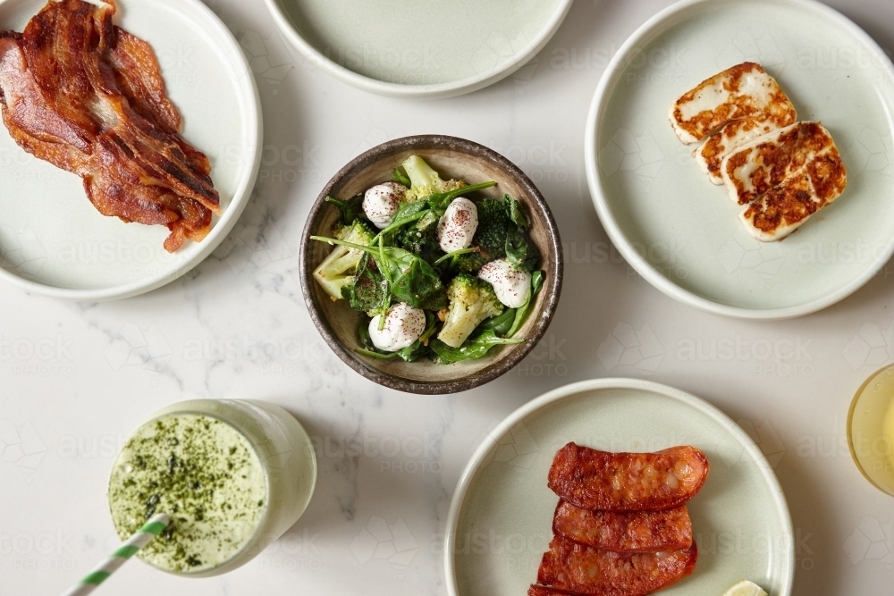Top shot of meat, salad and a drink served in a cafe. - Australian Stock Image