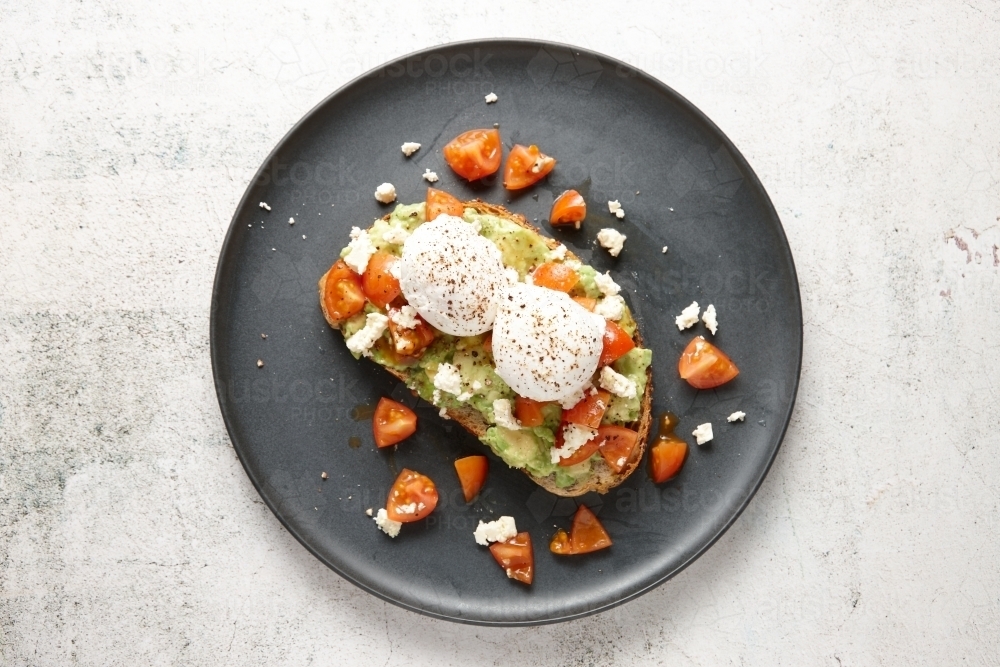 top shot of smashed avocado with poached eggs - Australian Stock Image