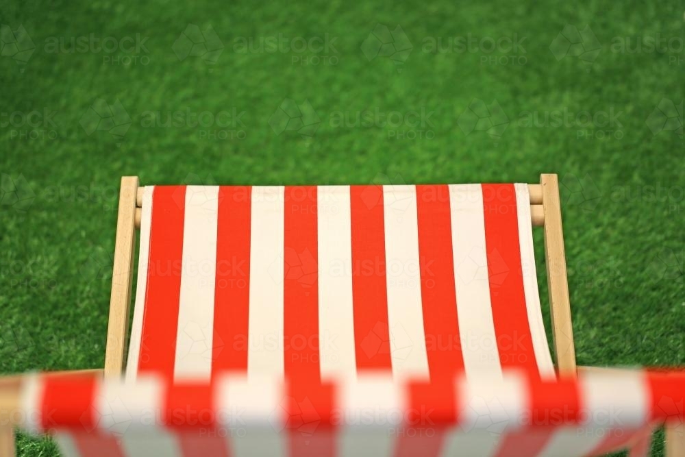 Top view of a red and white canvass lawn chair - Australian Stock Image