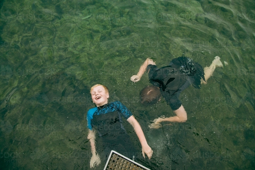 Image of Top view of kids swimming in clear blue water at the Bogey ...