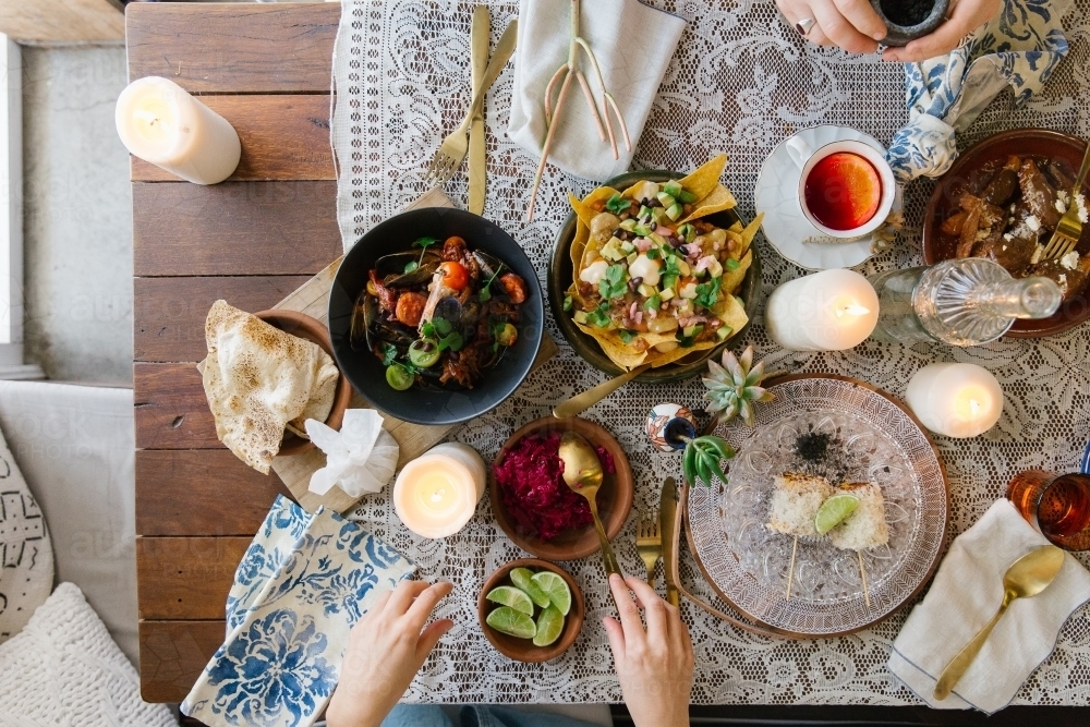 Top view shot of a woman's hand setting the table - Australian Stock Image