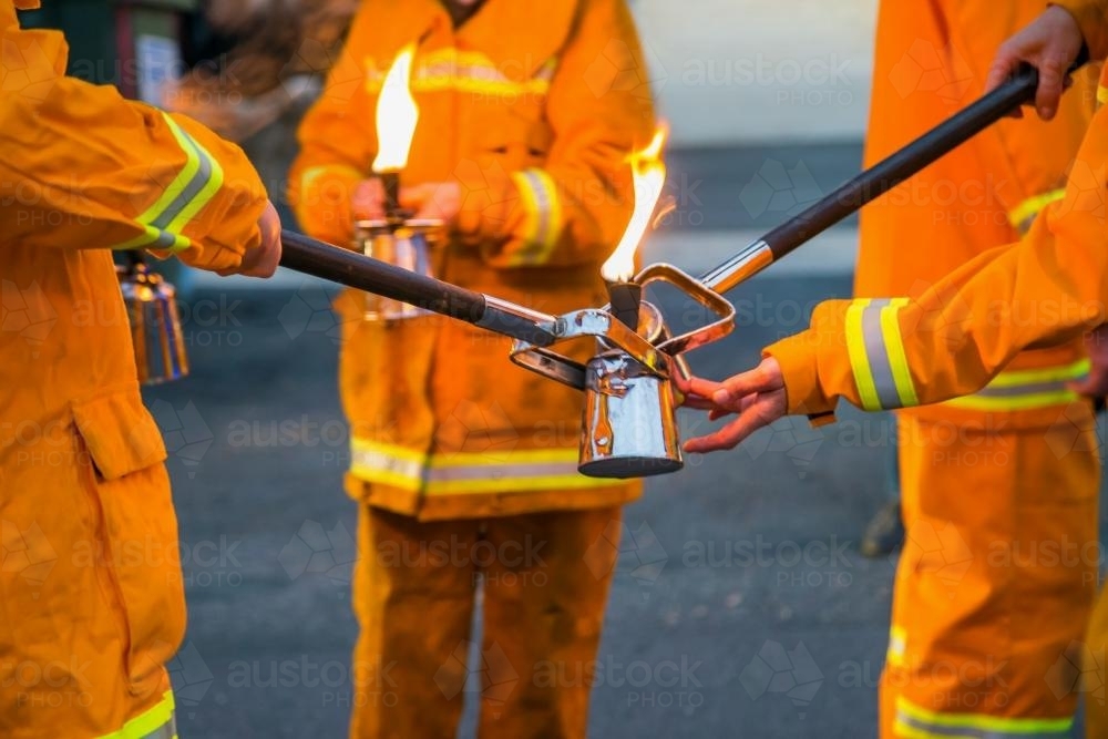 Torches being lit by firemen - Australian Stock Image