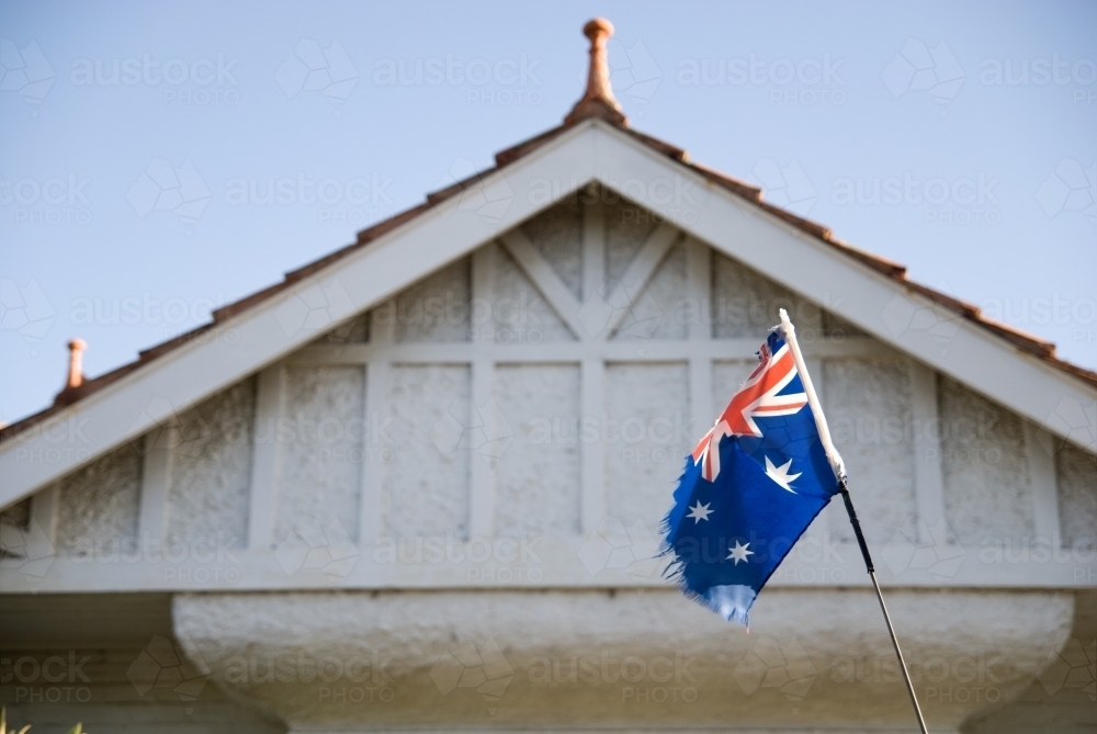 Torn Australian flag outside a house - Australian Stock Image
