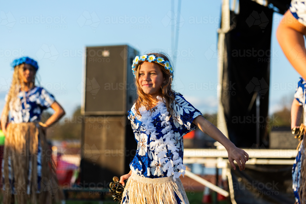 Torres Strait Islander child dancing and performing traditional dance at cultural spectacular event - Australian Stock Image