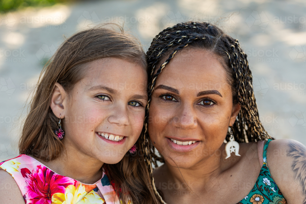 Torres Strait Islander girls face beside mother with hazel and brown eyes - Australian Stock Image