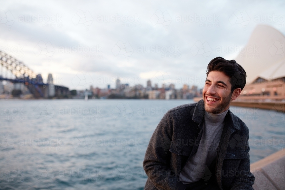 Tourist laughing with the Sydney Opera House in background - Australian Stock Image