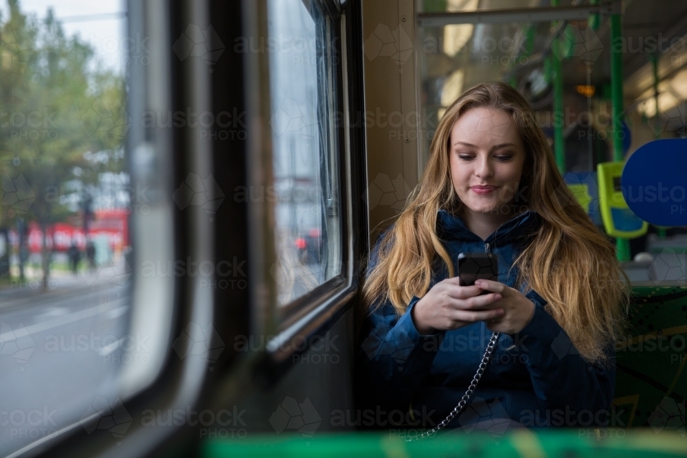 Tourist Texting on the Tram - Australian Stock Image