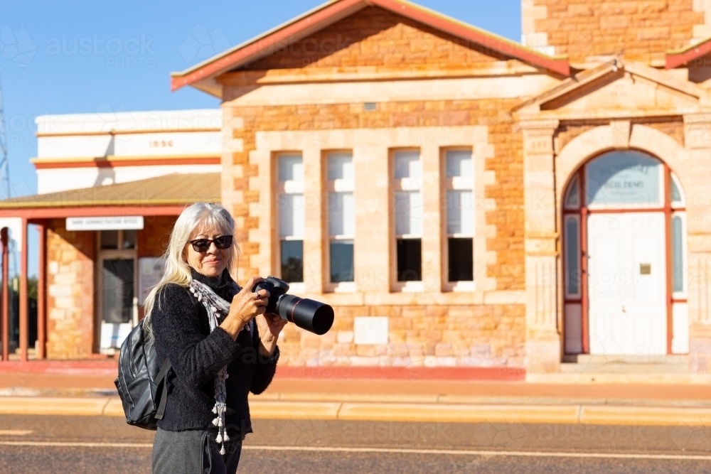 tourist with her camera at historic site - Australian Stock Image