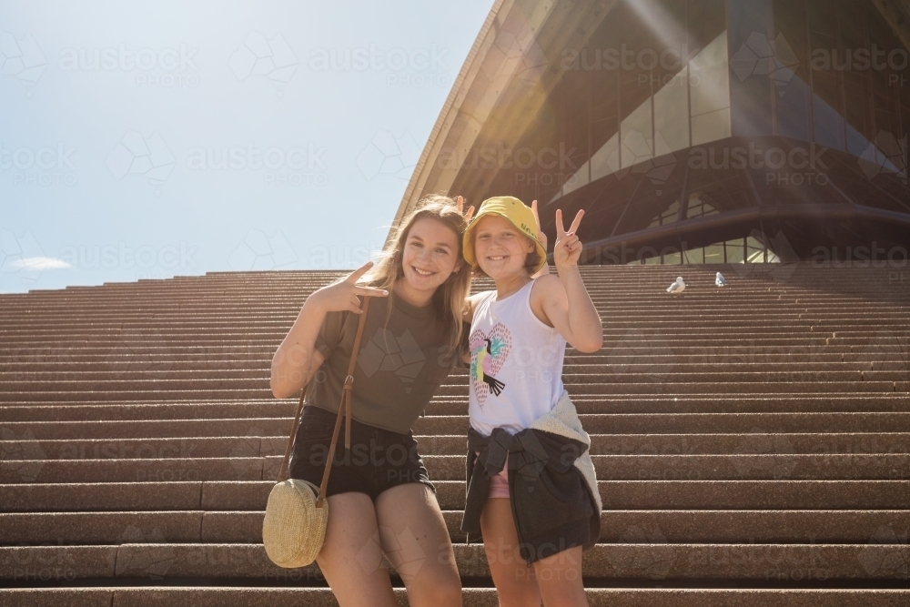 tourists posing in front of the opera house - Australian Stock Image