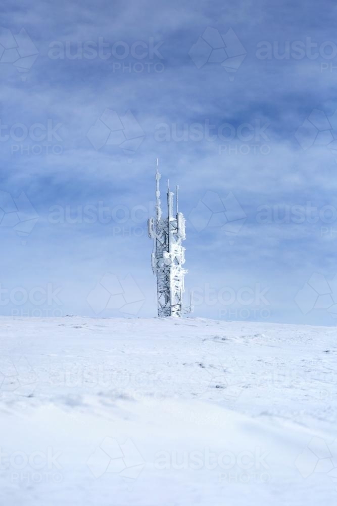 Tower on snow covered mountain - Australian Stock Image