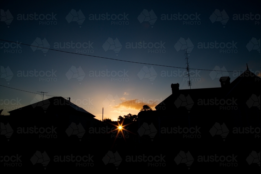Town house buildings silhouetted against sunset - Australian Stock Image
