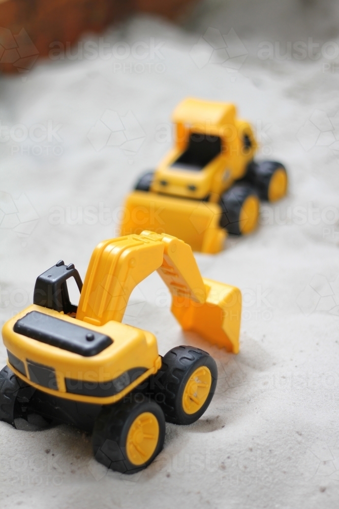Toy excavator in sandpit - Australian Stock Image