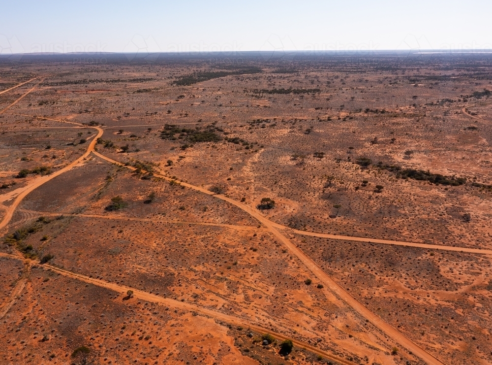 tracks criss-crossing an arid outback landscape - Australian Stock Image