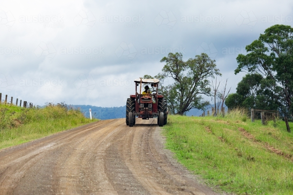 Tractor driving on country road - Australian Stock Image