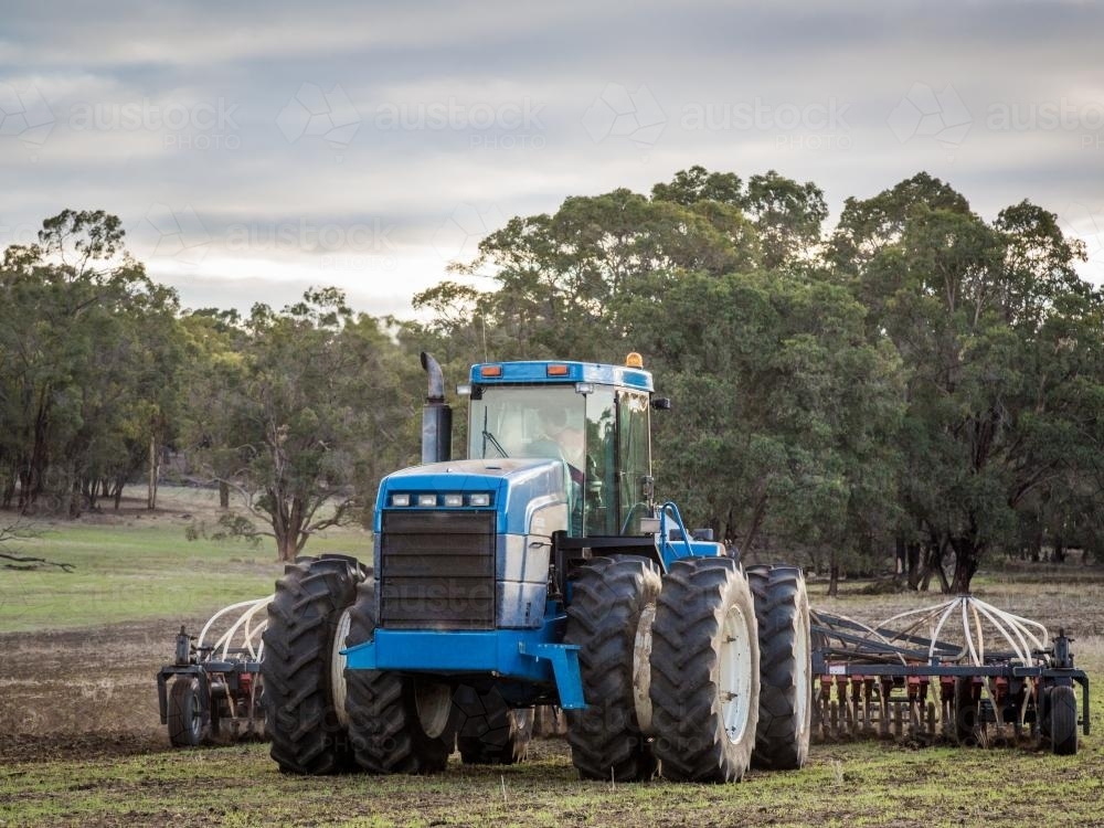 Tractor with air-seeder sowing crop in a paddock - Australian Stock Image