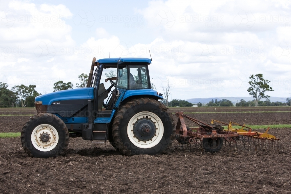 Tractor with Plow in Paddock - Australian Stock Image