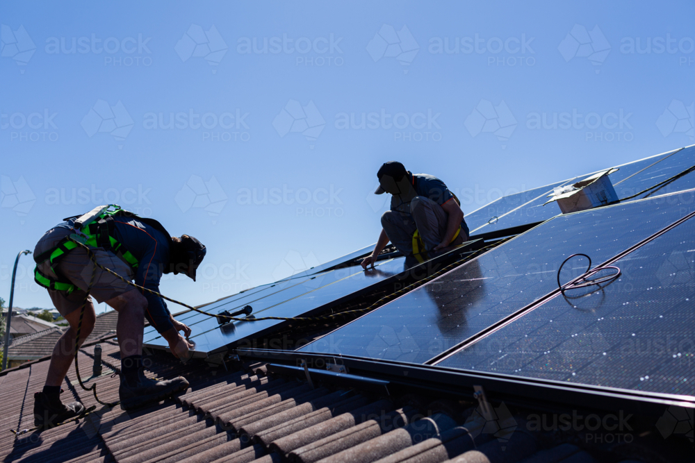 Apprentices Solar Image of Tradesman electrician and apprentice installing solar panel ...