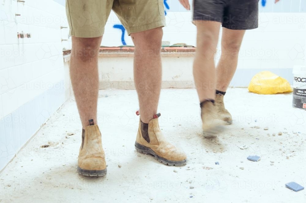 Tradesman wearing boots on construction site - Australian Stock Image