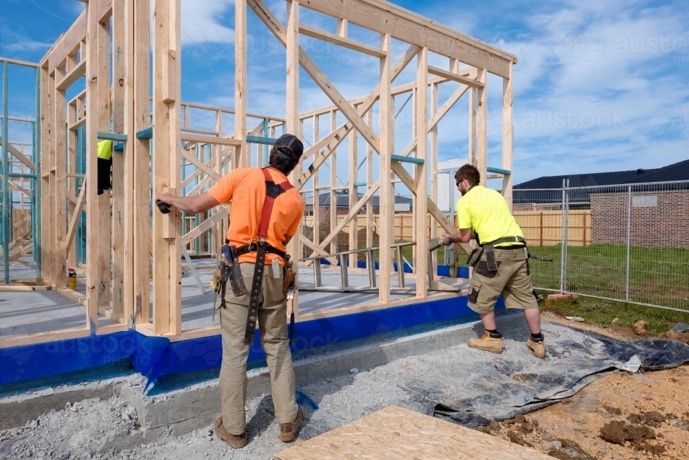 Image of Tradie working on house building site Austockphoto