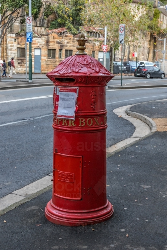 Traditional red postal mail box on city street in Sydney - Australian Stock Image