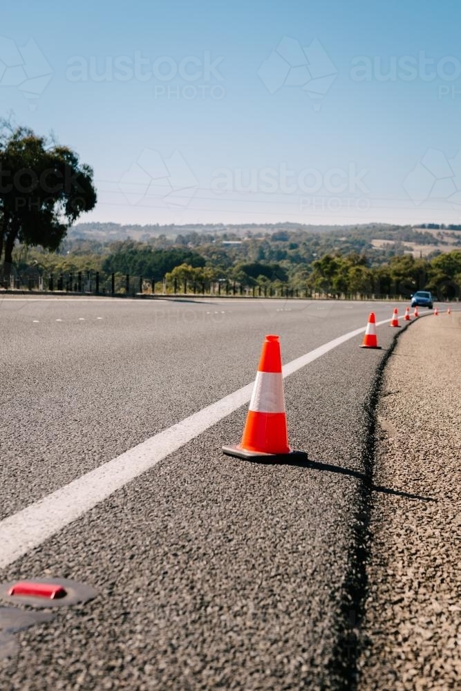 traffic cones on the side of highway - Australian Stock Image