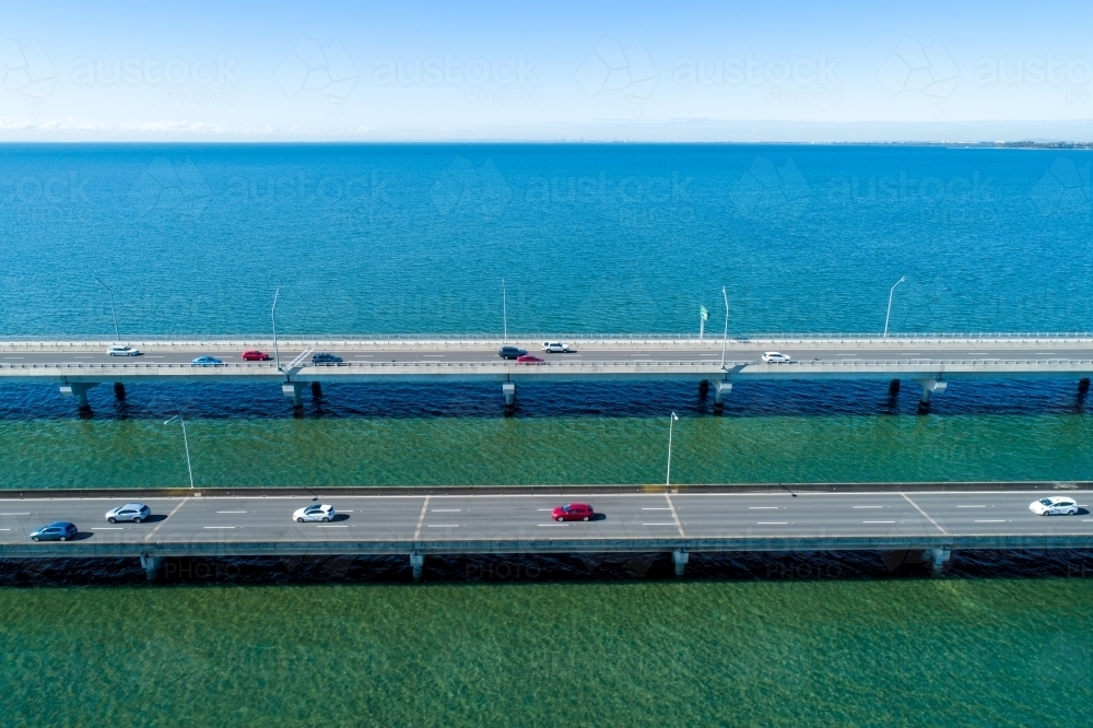 Traffic driving on two bridges over water. - Australian Stock Image