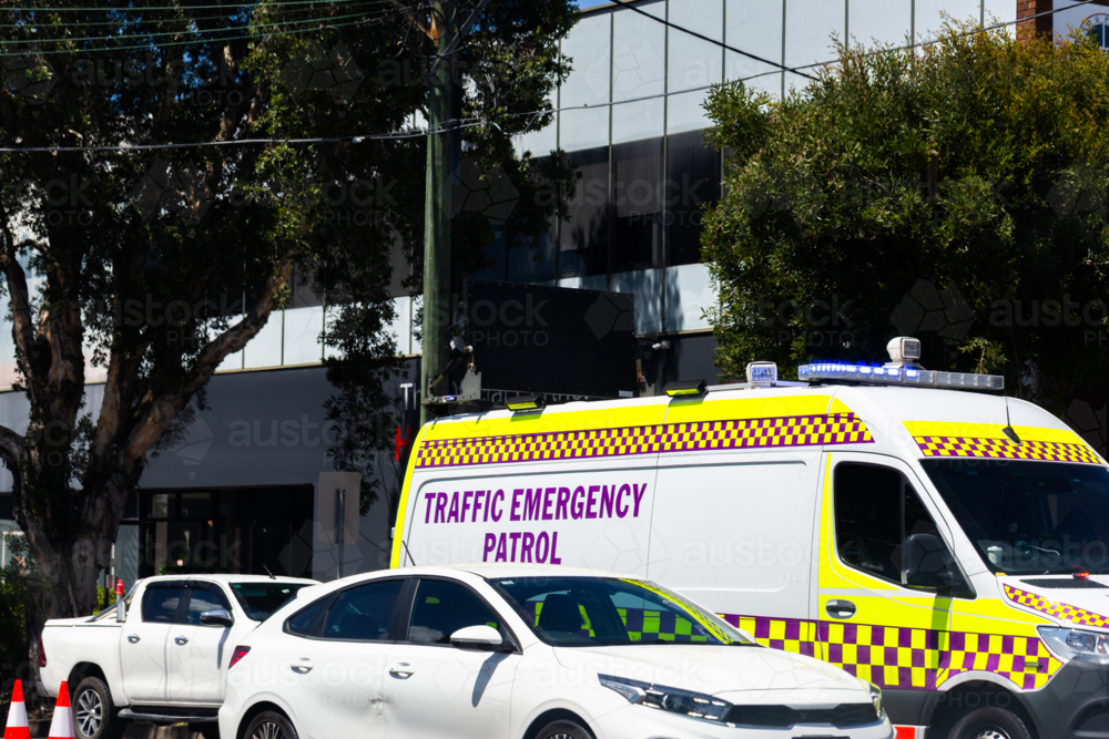 Traffic emergency patrol vehicle behind cars stopped on roadside in city - Australian Stock Image