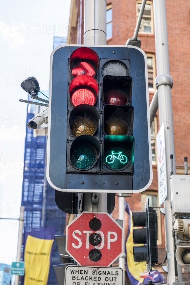 Traffic light signal with green cycle lamp and red stop and red right turn signal illuminated - Australian Stock Image
