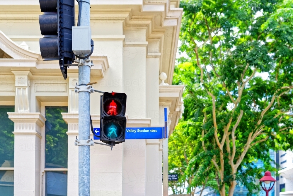 Traffic lights for pedestrian crossing, close up with old building behind - Australian Stock Image