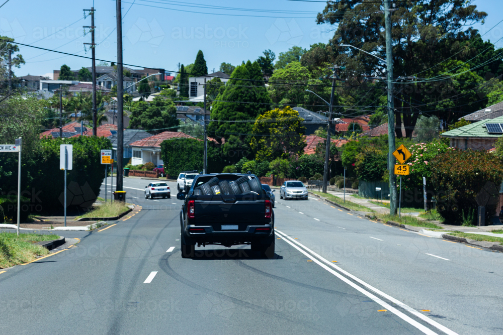 Traffic on city street seen through car window on the road - Australian Stock Image