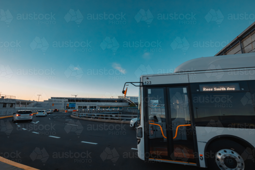 Traffic on road at Sydney Domestic Airport with plane coming in to land - Australian Stock Image