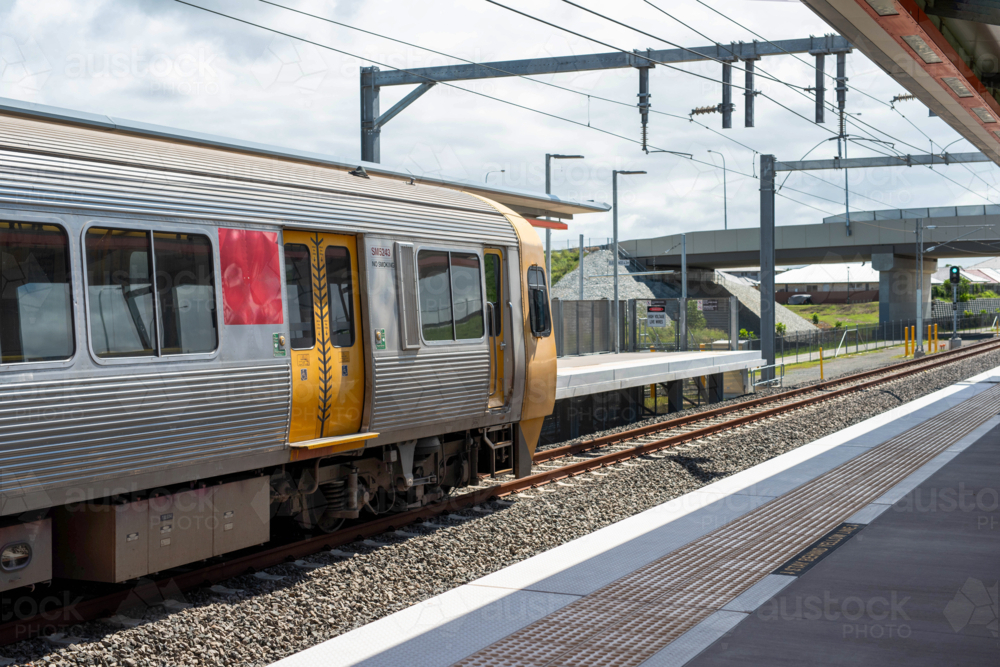 Train arriving at a railway station, Queensland, Australia - Australian Stock Image
