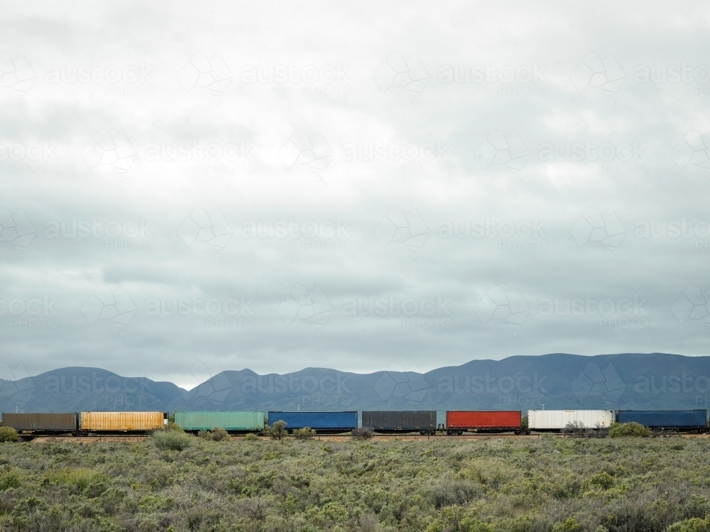 Train carriages with mountain range in background - Australian Stock Image