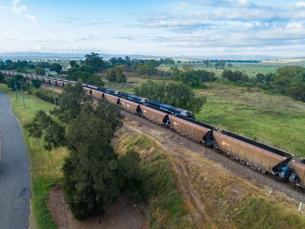 Train full of coal and empty train passing one another on railway - Australian Stock Image