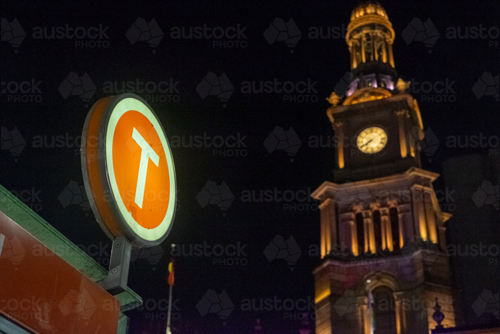 train sign with a lit up Sydney Town Hall on the background - Australian Stock Image