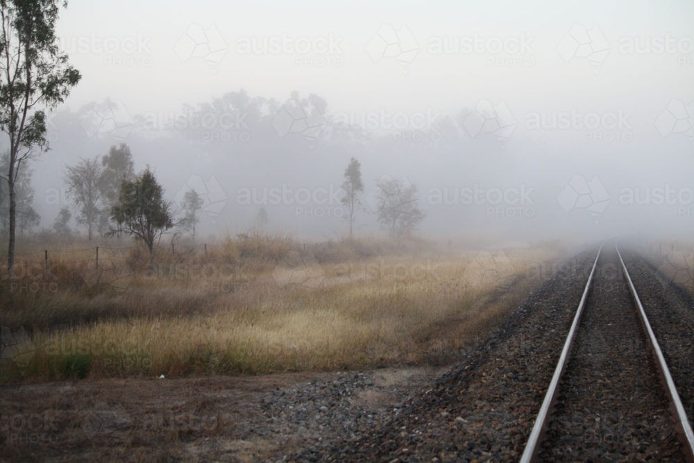 Train tracks disappearing into fog - Australian Stock Image