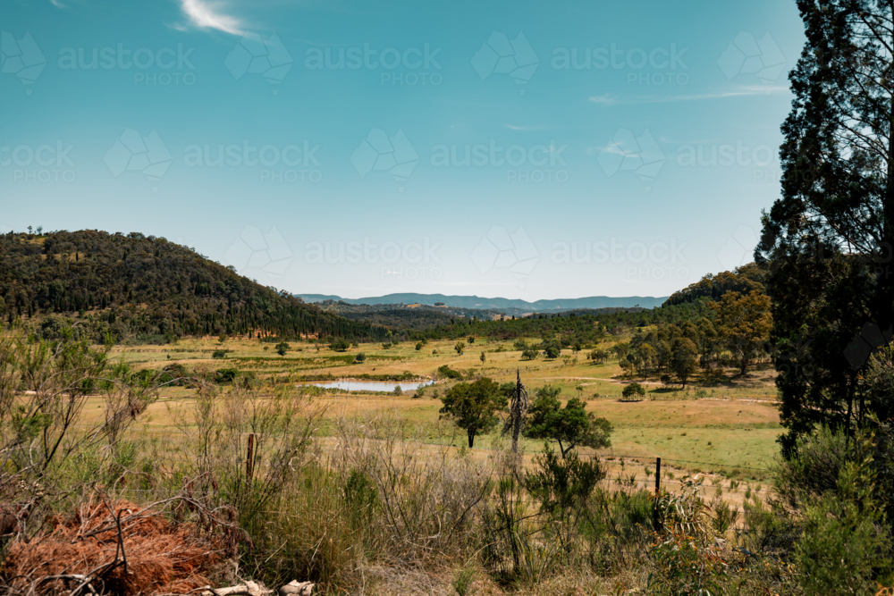 Image of Tranquil rural landscape with rolling hills and greenery under ...