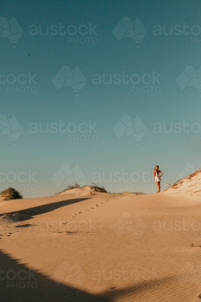 Tranquil Sunset Moments- young adult watching the sunset on the Sand Dunes - Australian Stock Image