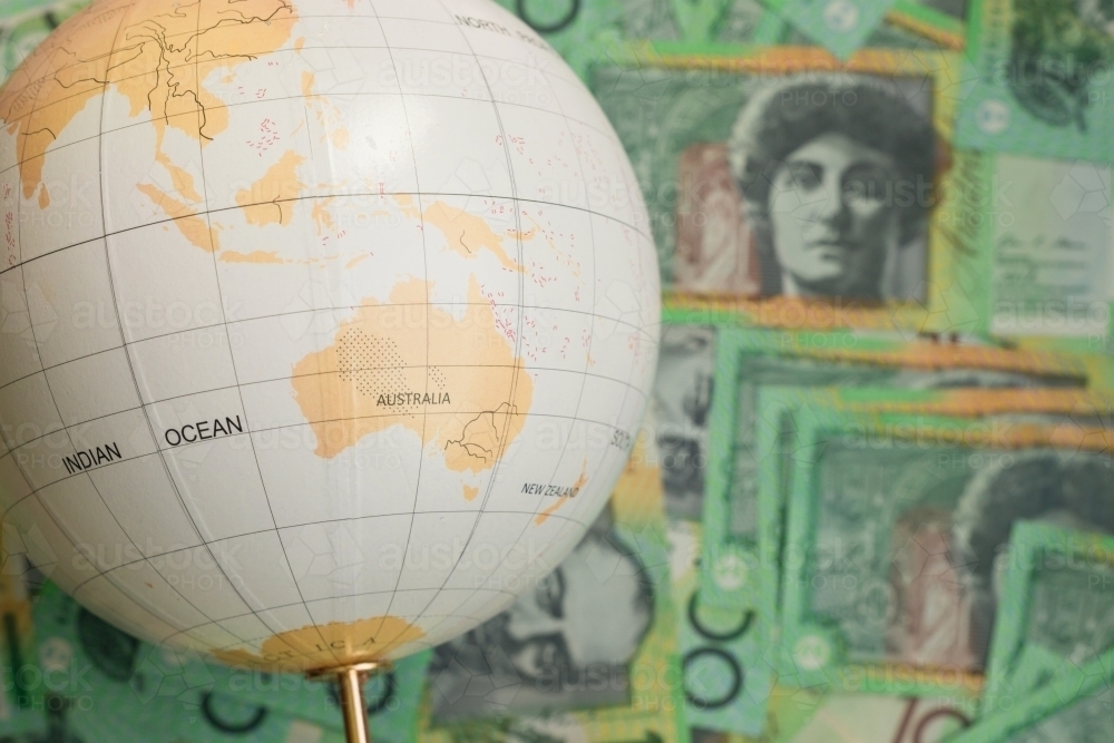 travel concept with globe and australian money - Australian Stock Image
